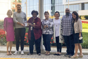 Photo of M.C. Dean CEO Bill Dean, CPO Tanya Moore, members of the HR team, and a representative of the Virginia Department of Aging and Rehabilitative Services.